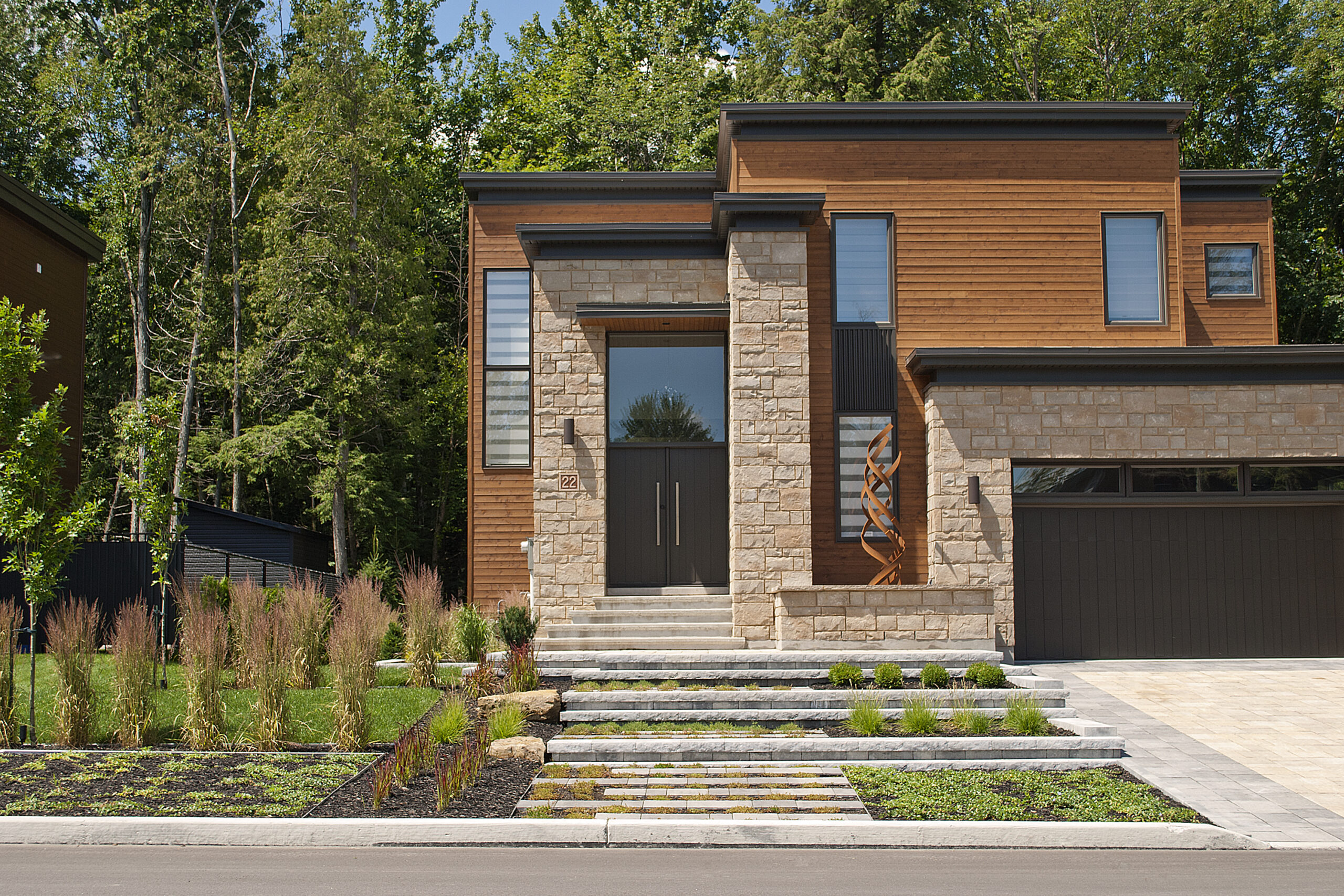 a house with a stone wall and a stone walkway